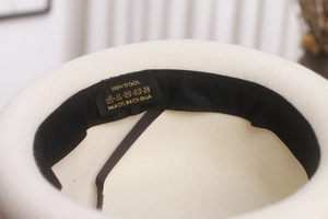 Detail shot of the internal 100% wool label and sweatband of the French wool beret