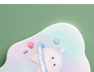 Close-up of portable hand mirror featuring cute cartoon planet design and smooth surface