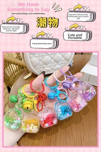 Close-up of colorful liquid sand backpack keychains with matching bells and clips
