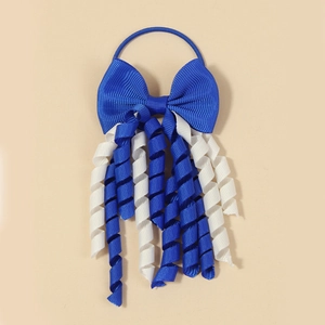 Detail of blue grosgrain bow hair tie with creative spiral tassel on plain background