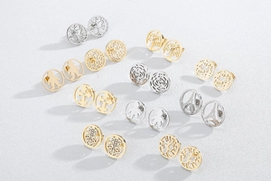 Collection of gold and silver stainless steel cutout earrings with diverse symbolic patterns