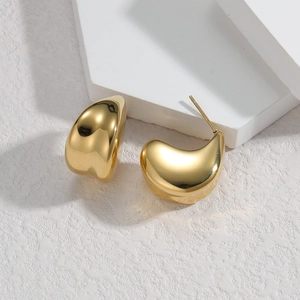 Minimalist gold-plated wide C-shape earrings with a polished mirror finish on white stand