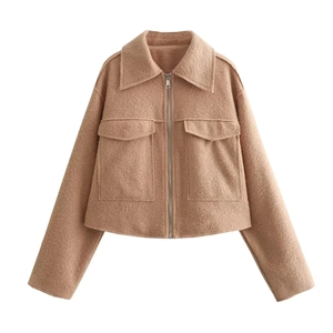 Detail of camel wool-blend jacket showing the lapel collar, zipper and large pockets