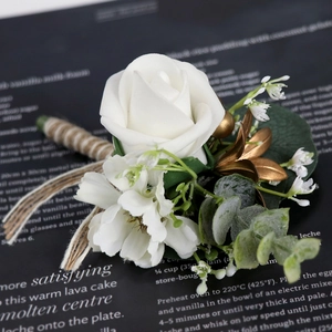 Elegant white PE rose boutonniere with greenery and gold leaves on twine-wrapped stem
