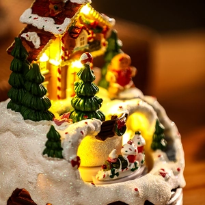 Detailed close-up of a festive Christmas musical house ornament with warm LED lights