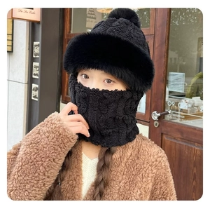 Detail of black winter knitted hat and neck warmer with plush lining for wind protection