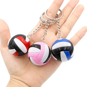 Miniature volleyball keychains in three colors with realistic stitch texture and metal rings