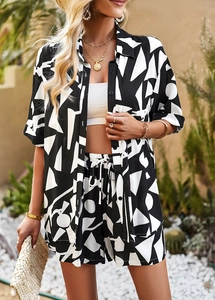 Detail of black and white geometric print pajama set with drawstring shorts and button shirt