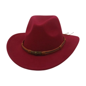 Detail of red felt cowboy hat featuring a braided brown band and vintage gold skull buckle