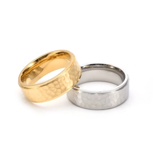 Macro detail of gold and silver titanium steel rings with hand-hammered texture