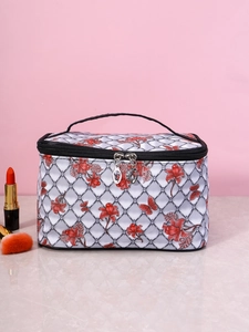 Detail of floral butterfly print makeup bag with black handle and silver metal zipper