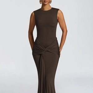 Detailed view of the elegant twist knot and draped ribbon on a slim fit brown dress