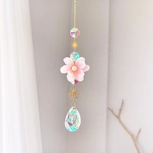 Crystal flower suncatcher with golden chain and iridescent teardrop prism for garden