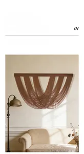 Detail of bohemian wall hanging with brown woven rope and dark wooden beam in a cozy room