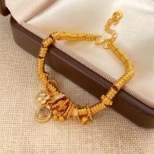 Elegant 24k gold floral charm bracelet with oval zircon and spiral beads on jewelry box