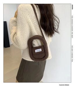 Detail of coffee brown handmade crochet mini crossbody bag on a child model's back