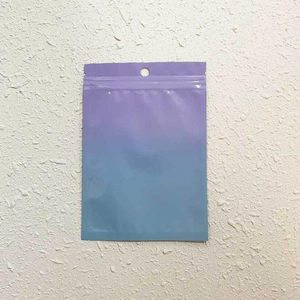 Detail of gradient purple to blue resealable laser bag with hanging hole and zip closure