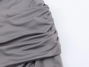 Detailed macro view of the grey ribbed knit fabric with professional ruched design textures
