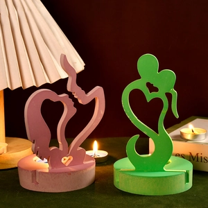 Abstract heart-shaped couple candle holder set in soft pink and green resin material