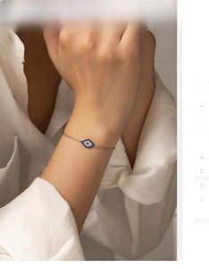 Close-up of S925 sterling silver evil eye bracelet with blue zircon on female wrist