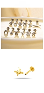 Macro view of titanium star and moon labret studs with zirconia inlays and flat back design