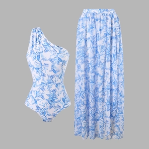 Detail of one-shoulder floral swimsuit and matching long skirt set in blue and white