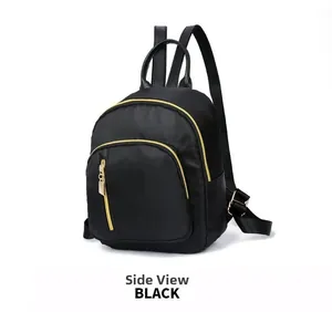 Side view of black nylon mini backpack with golden zippers and adjustable straps