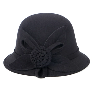 Close-up of black wool felt cloche hat featuring an elegant fabric flower decoration