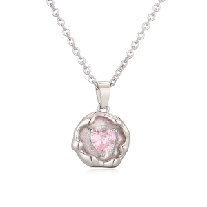 Detail of silver geometric necklace with a pink heart-shaped crystal pendant