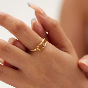 Minimalist 18K gold plated stainless steel ring with oval cutout and zircon on a hand