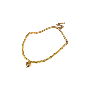 Minimalist gold beaded heart charm bracelet with polished metal finish on white background