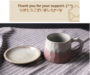Macro view of handmade ceramic coffee mug with hammer texture and pink-white glaze