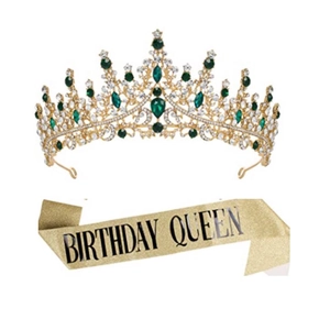 Detail of glitter birthday sash and gold metal crown set with green rhinestones