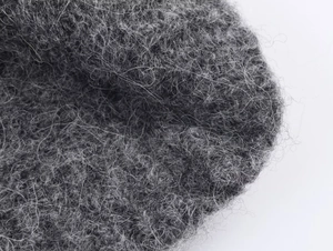 Close-up of charcoal grey wool blend fabric showing high-density fiber texture and quality