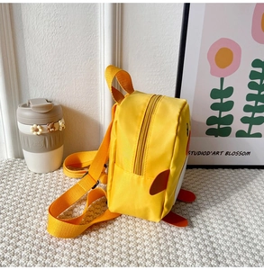 Side view of cute yellow duck mini backpack with orange bill for kids aged 1-5