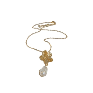 Vintage gold flower pendant necklace with irregular baroque pearl on white background