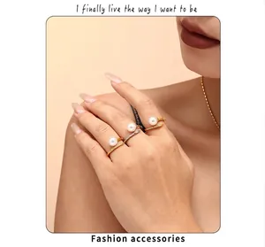 Detailed view of three stackable open rings with white pearls and micro-pave crystals