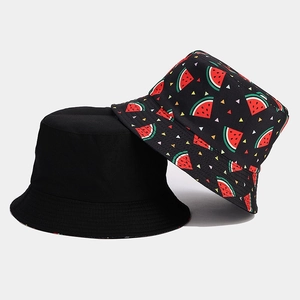 Detail of reversible bucket hat showing plain black side and watermelon print fabric