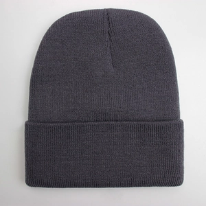 Close-up of dark grey knitted beanie showing fine wool texture and stitch detail