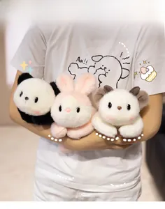 Three plush toys featuring a panda, pink rabbit, and white lamb held in hand
