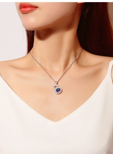 Macro detail of S925 silver gourd necklace with tanzanite blue gemstone and diamonds