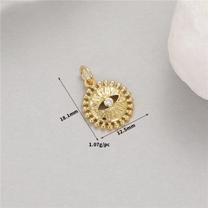 Macro detail of 14K gold evil eye sun pendant with 18.1mm height and 12.5mm width