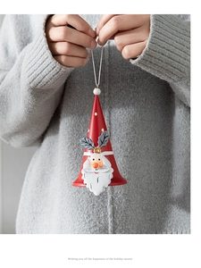 Detail of hand-held red Santa Claus iron bell ornament with white polka dots