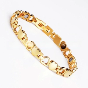 Detail of gold double heart magnetic link bracelet with energy therapy magnets