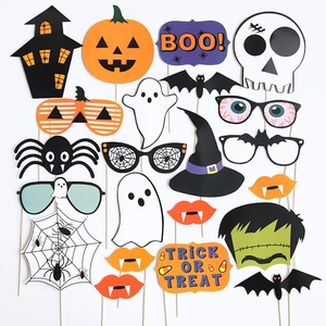 Flat lay of 22-piece Halloween photo booth props with pumpkins, ghosts, and witch hats