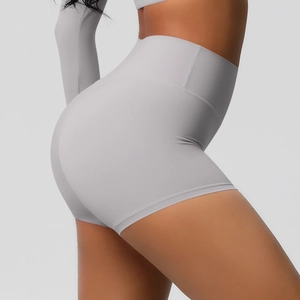 Close-up of high-waisted gray yoga shorts with peach-lift stitching and stretch fabric