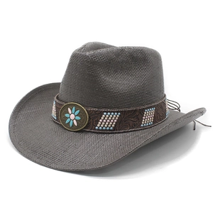 Western charcoal straw cowboy hat with ethnic beaded band and vintage bronze badge