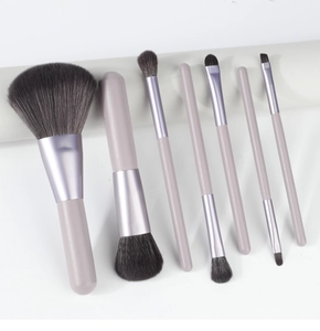 Detailed view of 7 soft makeup brushes with matte purple handles and fine grey bristles
