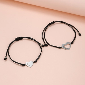 Set of two heart-shaped stainless steel bracelets for Mother and Daughter on pink background