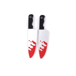 Macro detail of acrylic Halloween charms featuring realistic bloody knife and dagger prints